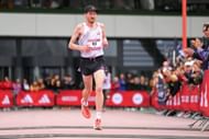 Reed Fischer at the finish line in the Men's 21.1 Km race at the 2023 Adizero: Road To Records in Herzogenaurach, Germany